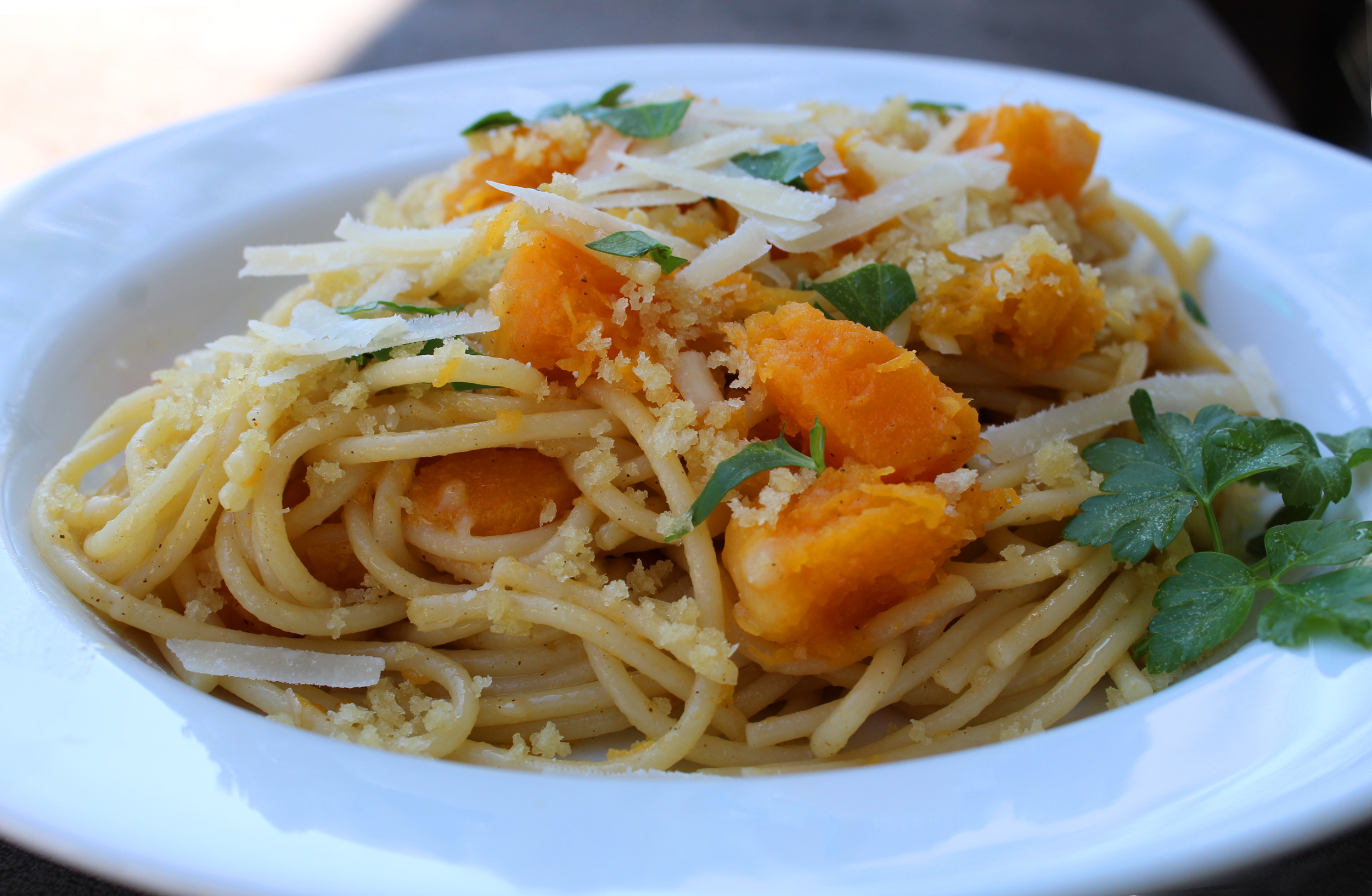 Colorful butternut squash pasta is ideal as a meatless main with fresh herbs, crispy Panko crumbs, shaved Parmesan cheese and baked squash