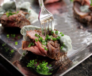 Beef tenderloin blue cheese bites with fresh chives and a mini plastic fork to hold it together