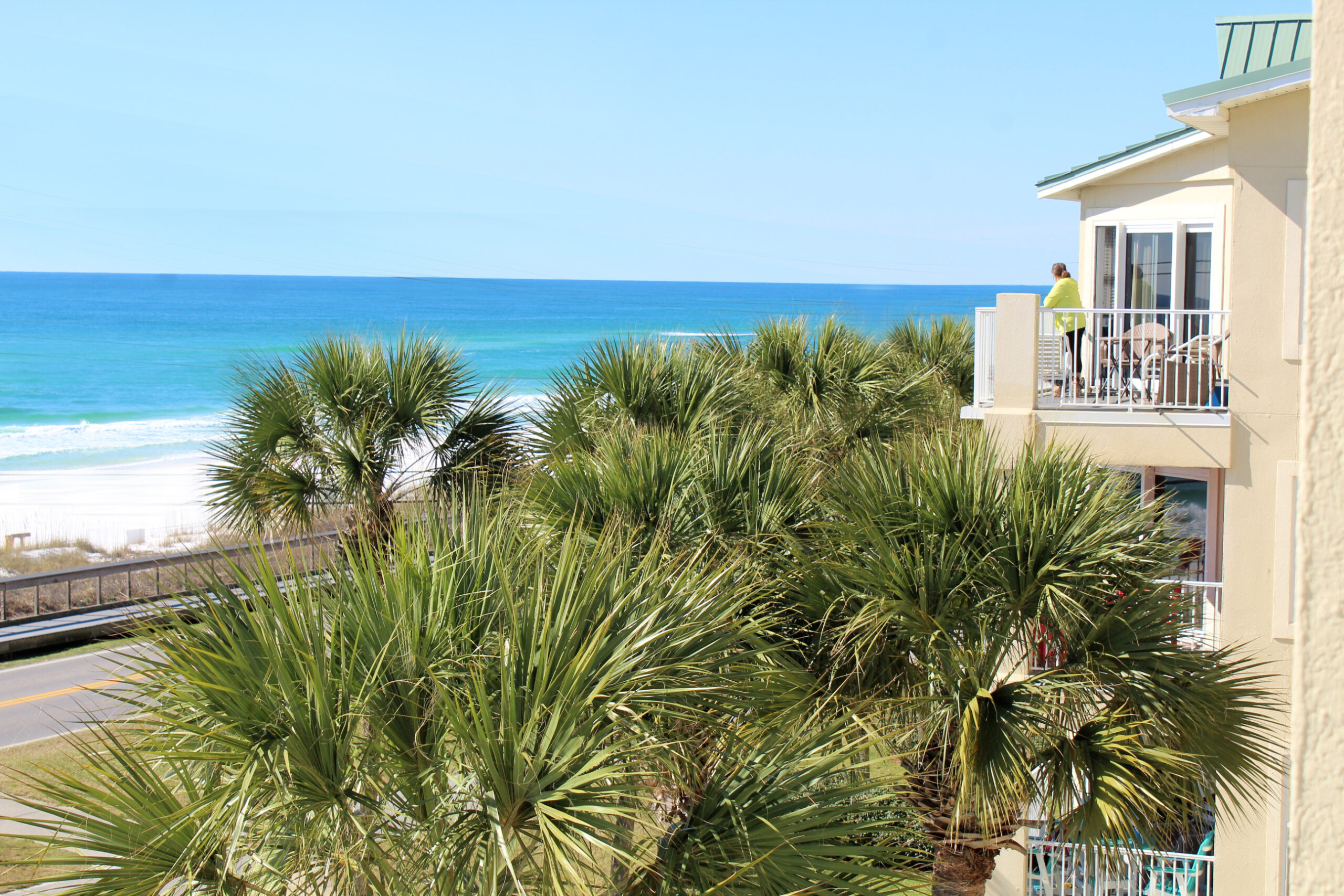view of the Gulf of Mexico with a woman standing on 4th floor balcony looking at the water