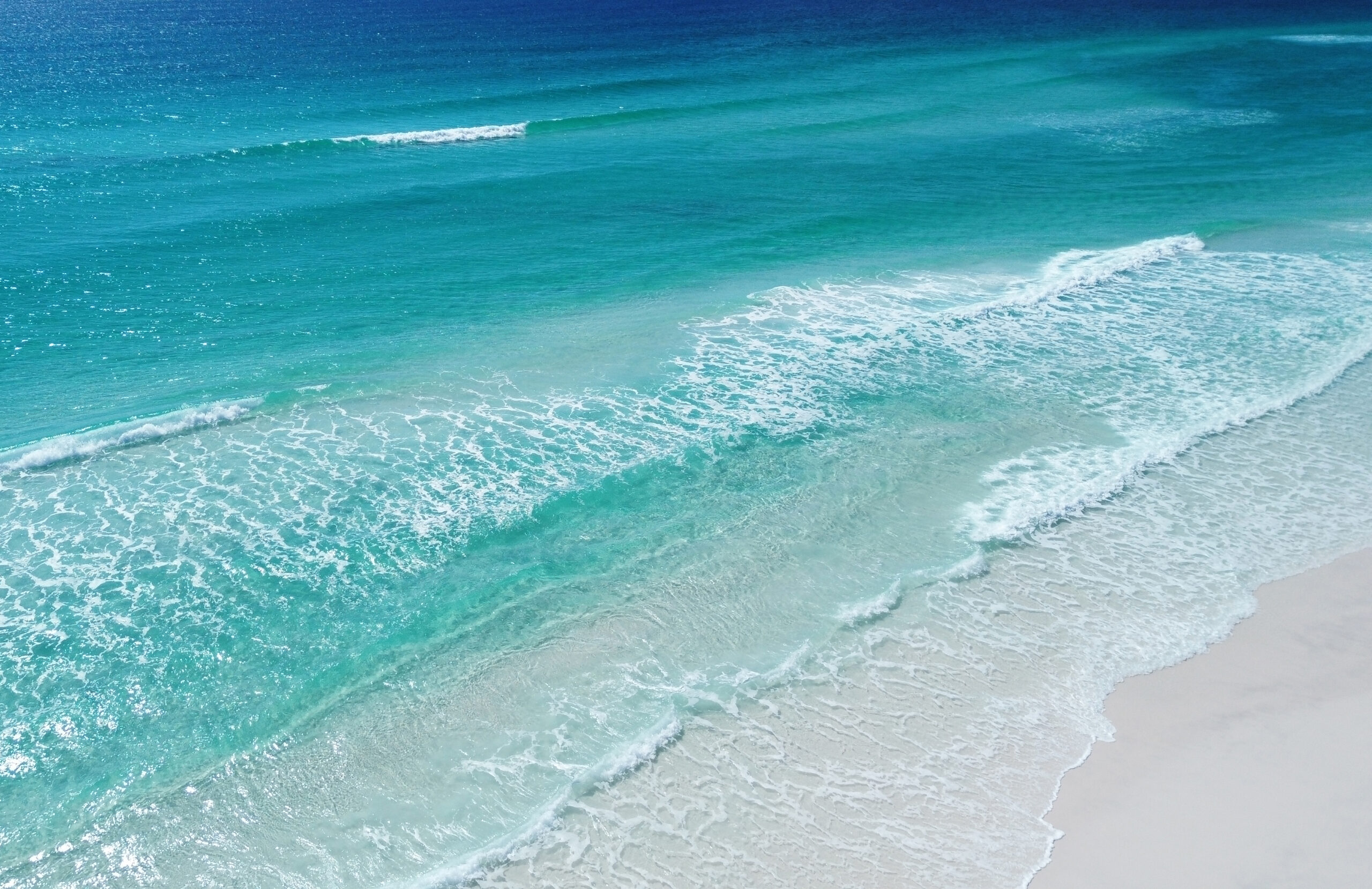 Drone view of gorgeous coastal waters of Miramar Beach in Northwest Florida. Both Florida and Hawaii are known for miles of scenic coastline and colorful hues